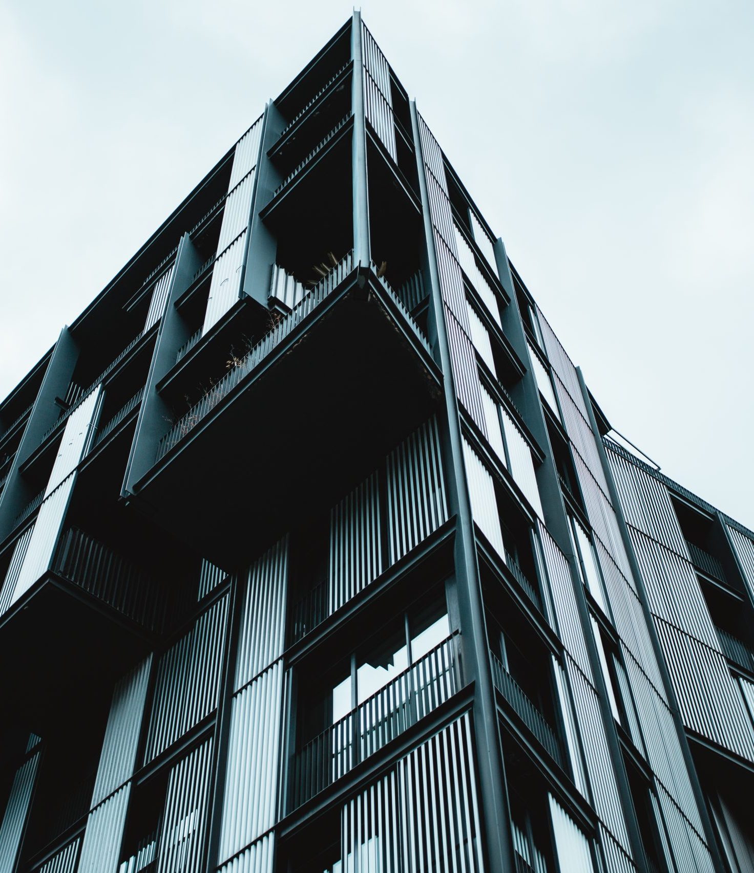 A low angle shot of a modern building with glass windows