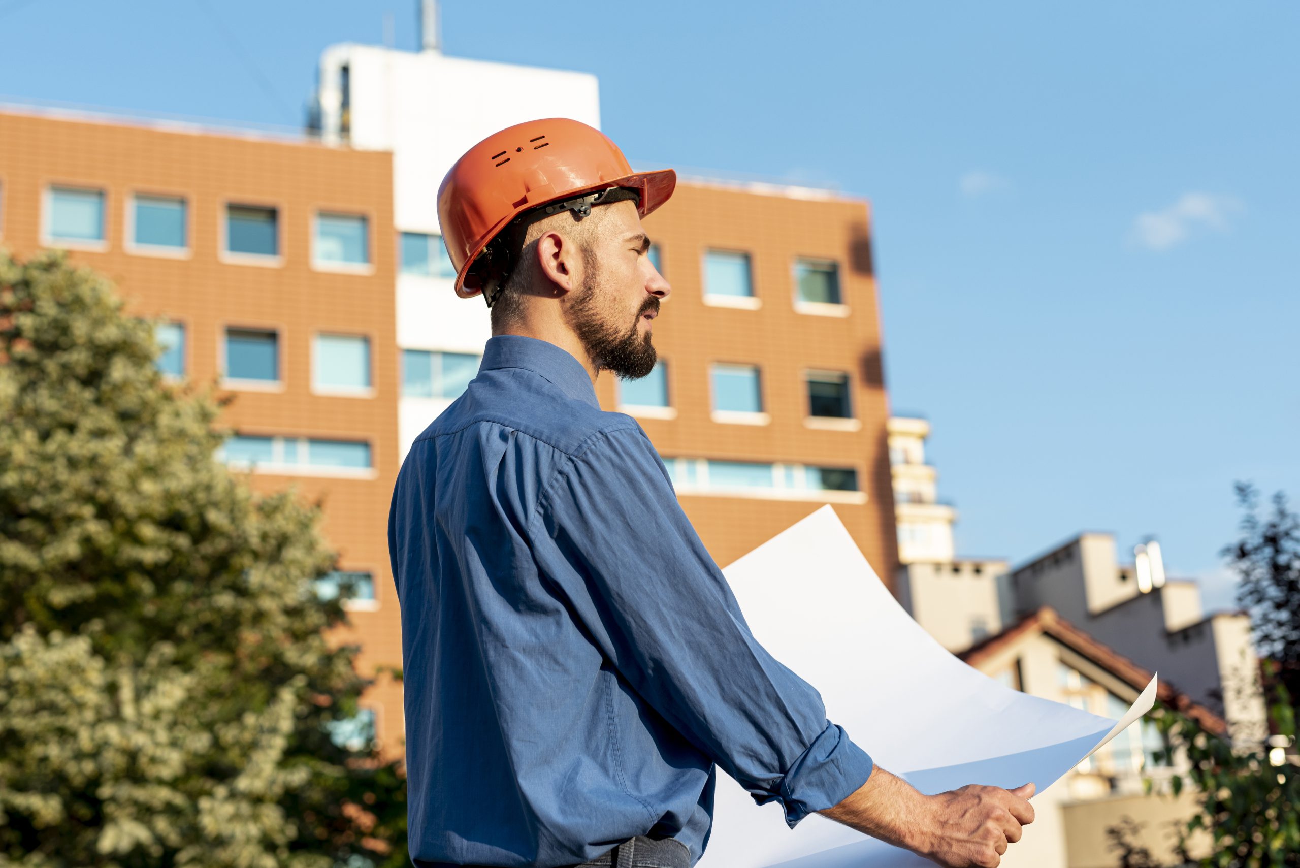 side-view-architect-holding-plans